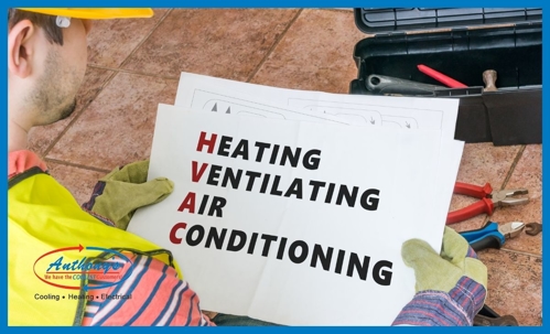 technician looking at piece of paper that says HVAC